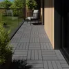A balcony with grey composite decking tiles, a chair, and a plant. Náhled obrázku produktu
