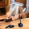 A person is using a woodworking tool under the light of a flexible LED lamp. Podgląd zdjęcia produktu