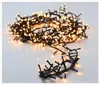 A pile of warm white LED cluster lights on a white surface. Produktbild-Vorschau