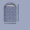 A dog sleeping bag with a bone pattern is shown with dimensions indicated. Podgląd zdjęcia produktu
