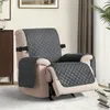 A recliner chair with a gray quilted cover, set in a living room. Anteprima dell’immagine prodotto