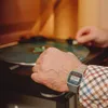 A person's hand wearing a Casio watch is shown near a turntable. Produktbild-Vorschau
