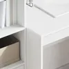 A close-up view of a white desk and a bookshelf with books and a storage box. Produktbild-Vorschau