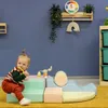 A baby playing with soft play blocks in a playroom. Produktbild-Vorschau