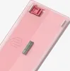 The back of a pink mechanical keyboard with a small silver component attached. Voir les images du produit