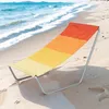 A colorful beach chair sits on a sandy beach with the ocean waves in the background. Náhled obrázku produktu