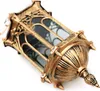 A close-up, angled view of a decorative, gold-colored lantern with glass panels, set against a white background. Voir les images du produit