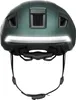 The back view of a green bicycle helmet with a white LED light strip across the front. Náhled obrázku produktu