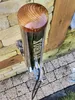 A close-up shot of a silver smoke generator with a wooden top, mounted on a stone wall. Produktbild-Vorschau