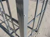 A close-up view of a gray metal frame structure, possibly part of a pavilion or shelter, set against a sandy background. Produktbild-Vorschau