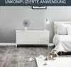 A white desk fan is placed on a white cabinet in a bedroom setting. There is a bed in the background and toys on the floor. Náhľad obrázku produktu