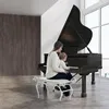 A woman and a baby are sitting at a grand piano. Náhled obrázku produktu