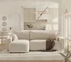 A modern living room with a sectional sofa, kitchen area, and dining table. Voir les images du produit