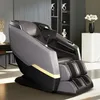A modern massage chair in a well-lit room with shelves in the background. Produktbild-Vorschau