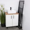 A bathroom vanity with a sink and a folded drying rack leaning against the wall. Produktbild-Vorschau