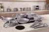 A set of grey cookware and utensils arranged on a kitchen countertop. Náhled obrázku produktu