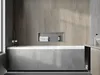 A modern bathroom with a built-in bathtub and a recessed shelf holding towels and a bottle. Náhled obrázku produktu