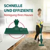A woman is vacuuming her home with a green vacuum cleaner, with a close-up of the vacuum head in the foreground. Produktbild-Vorschau