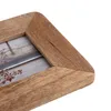Close-up of a wooden picture frame corner with a blurred image inside. Podgląd zdjęcia produktu