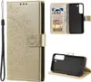 Collage of images showing a gold mandala-embossed flip phone case for a Samsung Galaxy S22 5G, including its interior card slots and the phone holder. Produktbild-Vorschau