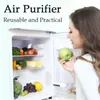 A woman is holding a green apple and looking into an open refrigerator filled with fruits and vegetables. An air purifier is visible inside the refrigerator. Náhľad obrázku produktu