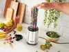 A Russell Hobbs personal blender filled with fruit and greens, with various fruits and prepared smoothies on a kitchen counter. Náhled obrázku produktu