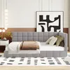 A modern bedroom scene featuring a gray upholstered daybed with pillows and a throw blanket. Náhled obrázku produktu