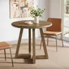 A round dining table with two chairs in a dining room setting. Anteprima dell’immagine prodotto