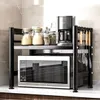 A kitchen counter with a microwave and a two-tier shelf unit holding various kitchen items. Náhľad obrázku produktu