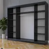 A black wardrobe with shelves and a hanging rod, set against a concrete wall and wooden floor. Produktbild-Vorschau
