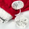 A close-up view of a red Christmas sack with white faux fur trim and two grey and white pom-poms. Produktbild-Vorschau