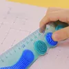 A hand is holding a ruler over a grid paper. Náhľad obrázku produktu