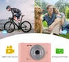 Collage showing a person cycling, a couple with a dog in a park, and a pink digital camera with feature callouts. Náhled obrázku produktu