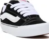 A close-up, studio shot of a black and white Vans sneaker. Voir les images du produit