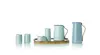 A set of kitchenware items including cups, a sugar bowl, and pitchers arranged on a wooden tray against a white background. Produktbild-Vorschau