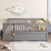A child's bed with a cloud and star light fixture above it. Voir les images du produit