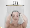A woman is showering with a large shower head. Produktbild-Vorschau
