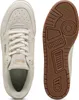 A top-down view of a cream-colored Puma sneaker and a view of its brown rubber sole. Produktbild-Vorschau