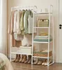 A white clothing rack with clothes and accessories is shown in a room. Produktbild-Vorschau