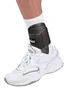 A person's ankle wearing a white sock, a black Mueller ankle brace, and a white athletic shoe. Produktbild-Vorschau