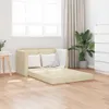 A cream-colored sofa bed is unfolded in a room with wooden floors, a window with blinds, and a plant. Produktbild-Vorschau