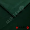 A close-up of dark green velvet fabric, folded to show texture and depth. Produktbild-Vorschau