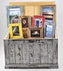 A collection of vintage-style picture frames of various colors and sizes are displayed inside a distressed wooden chest. Voir les images du produit