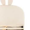 Close-up of a bed frame with a beige upholstered headboard and bunny ears. Produktbild-Vorschau