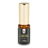 A small bottle of perfume with a gold cap and a black label. Produktbild-Vorschau