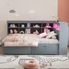 A child's bedroom with a grey daybed, bookshelf headboard, and decorative wall elements. Produktbild-Vorschau