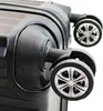 A close-up view of the wheels and lower part of a black suitcase. Produktbild-Vorschau
