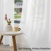 A close-up view of white sheer curtains hanging in a window, with a small table holding a vase of tulips and a mug in the foreground. Produktbild-Vorschau