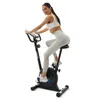 A woman is riding an exercise bike. Produktbild-Vorschau