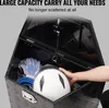 A hand places a white helmet into an open black aluminum storage box filled with other items. Podgląd zdjęcia produktu